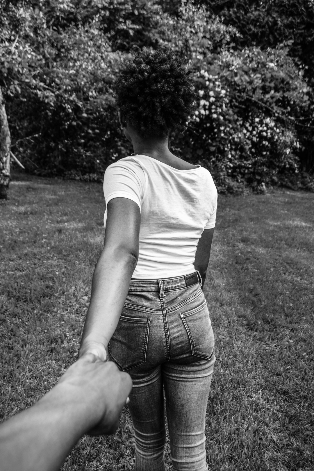 black woman leading her man by the hand